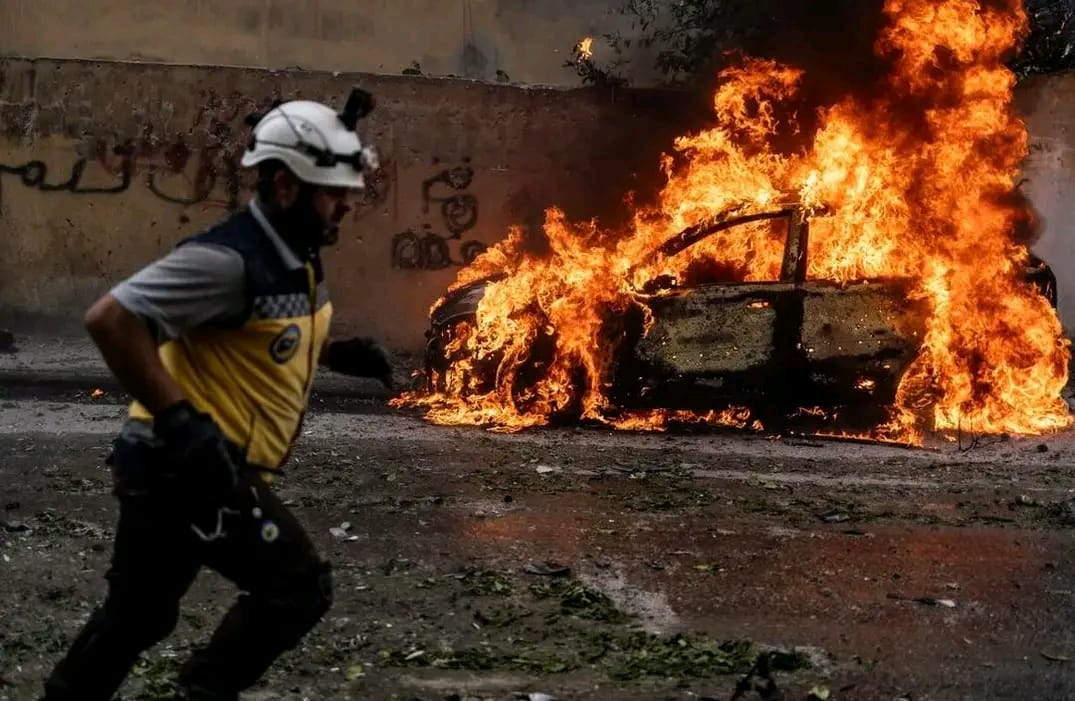 Three people walking past a building